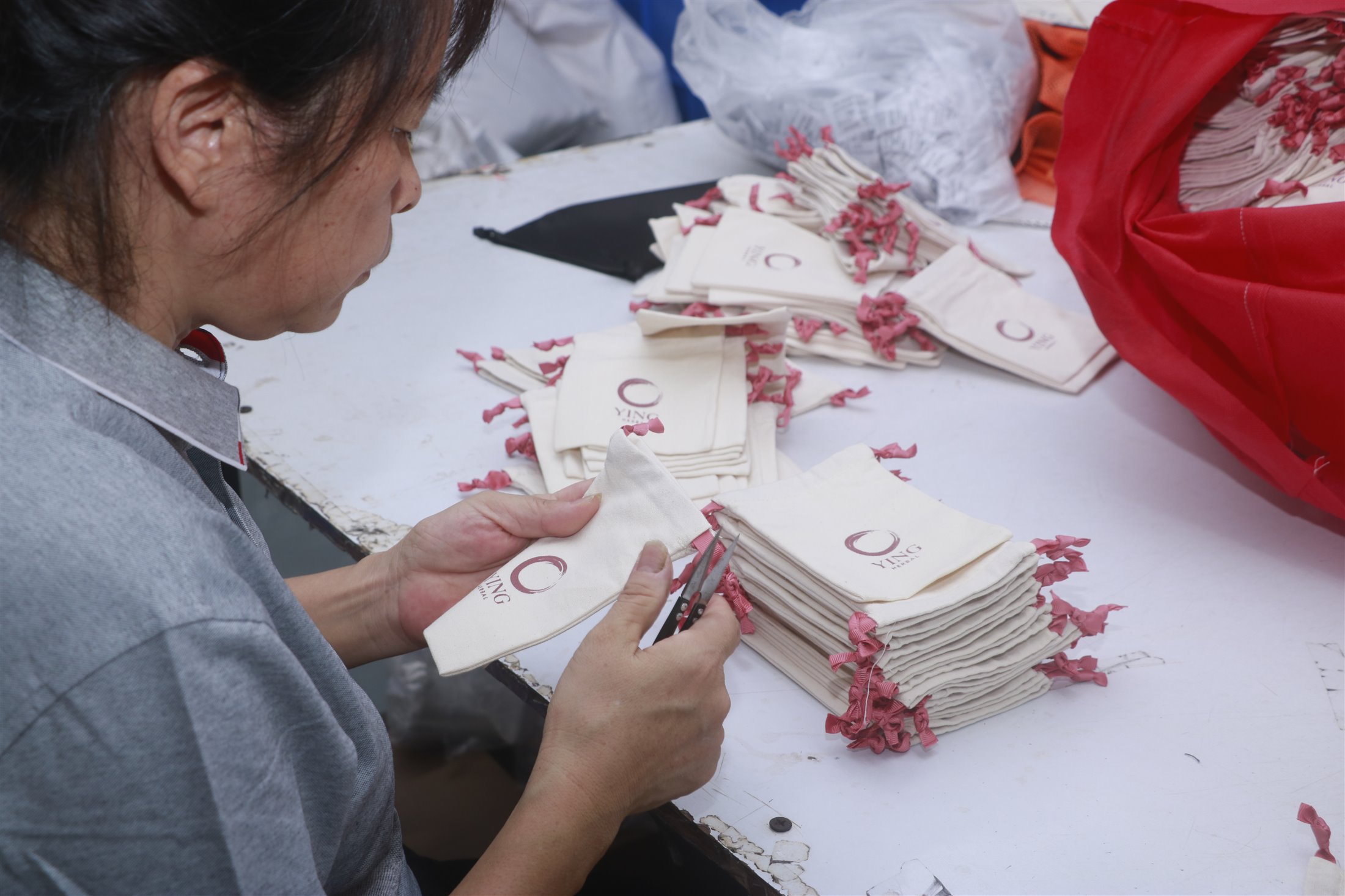 Quality inspection of custom fabric drawstring bags before packing